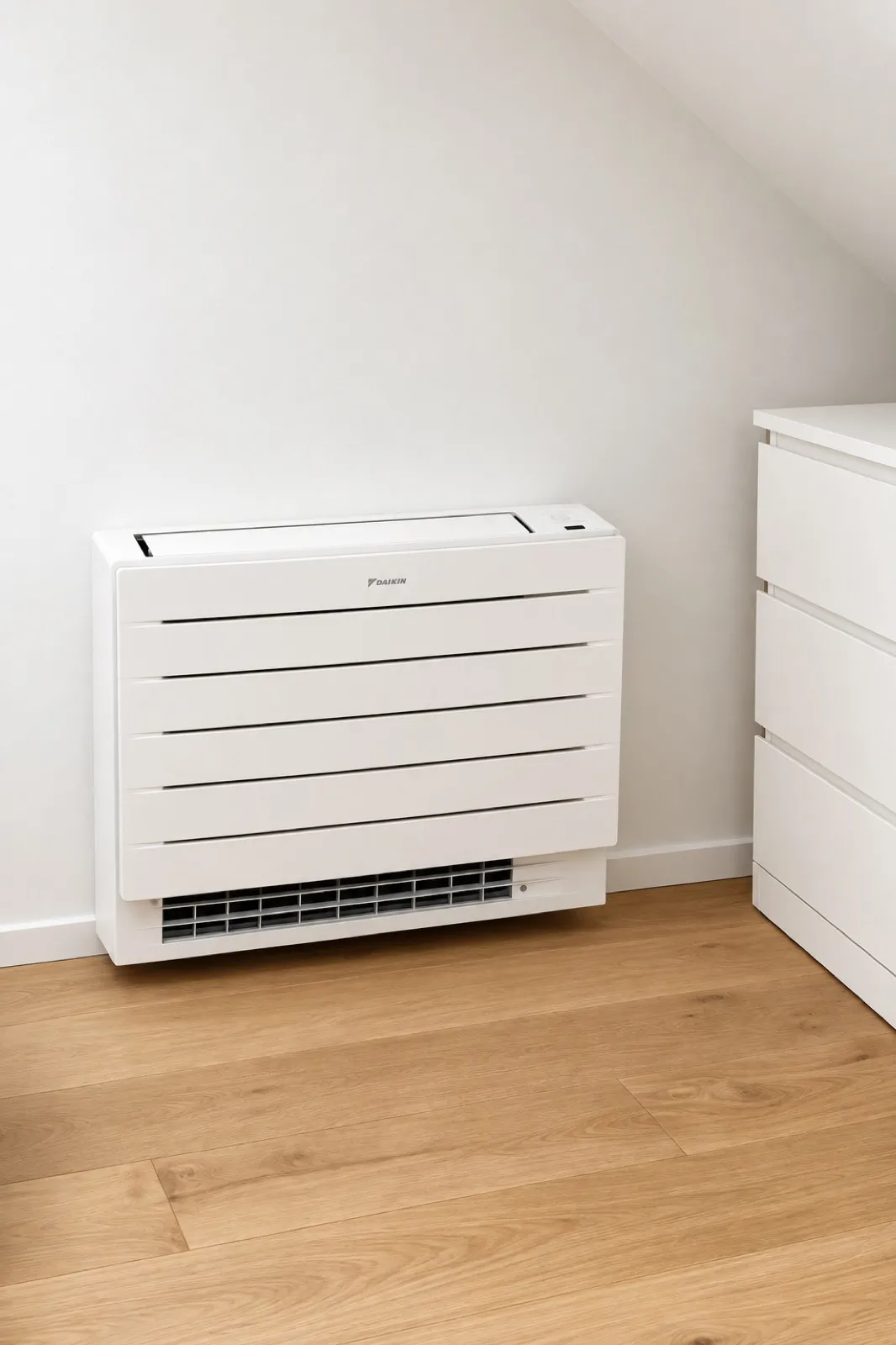 Floor-standing air conditioning unit installed under a window